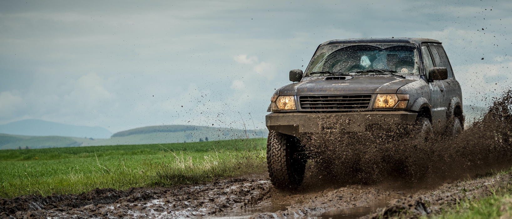 SUV driving through mud